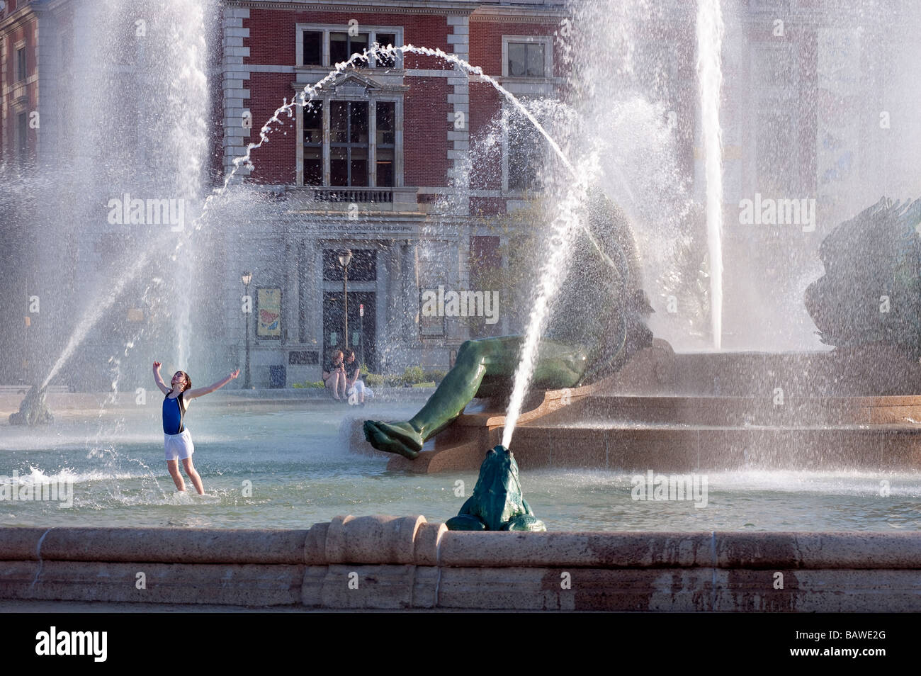 Girl playing in Swann Fountain in Logan s Circle Philadelphia Pennsylvania Stock Photo