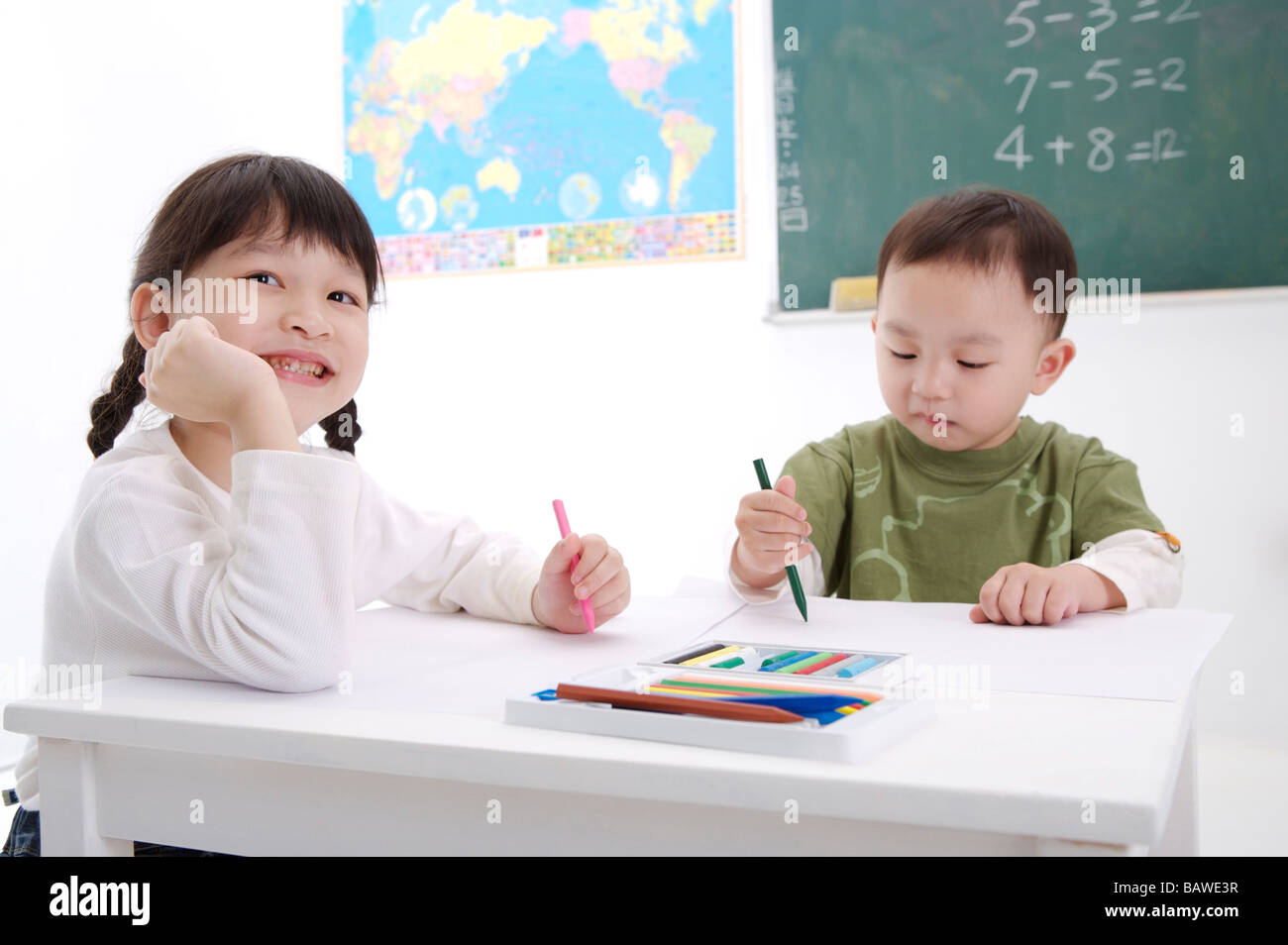 Children drawing with colored pencils Stock Photo