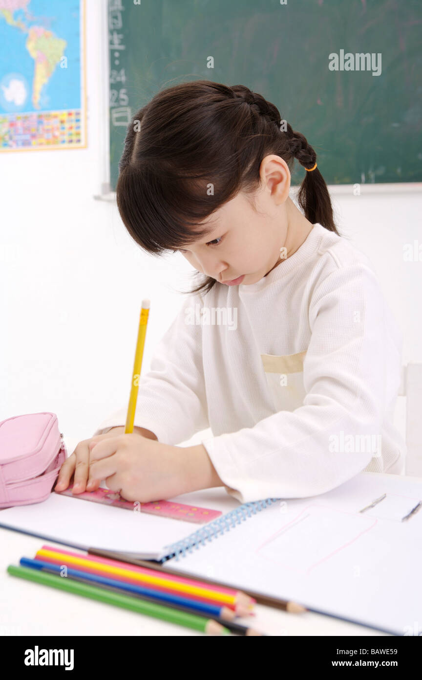 Girl doing homework Stock Photo