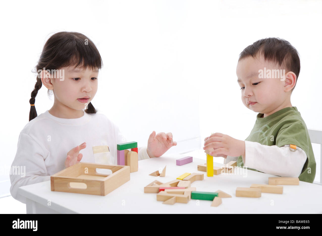 Children playing bricks in classroom Stock Photo - Alamy