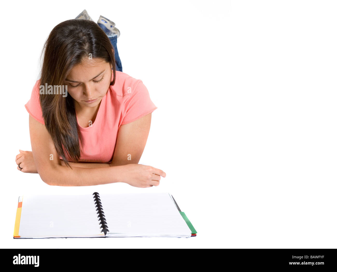 girl reading a notebook on the floor Stock Photo