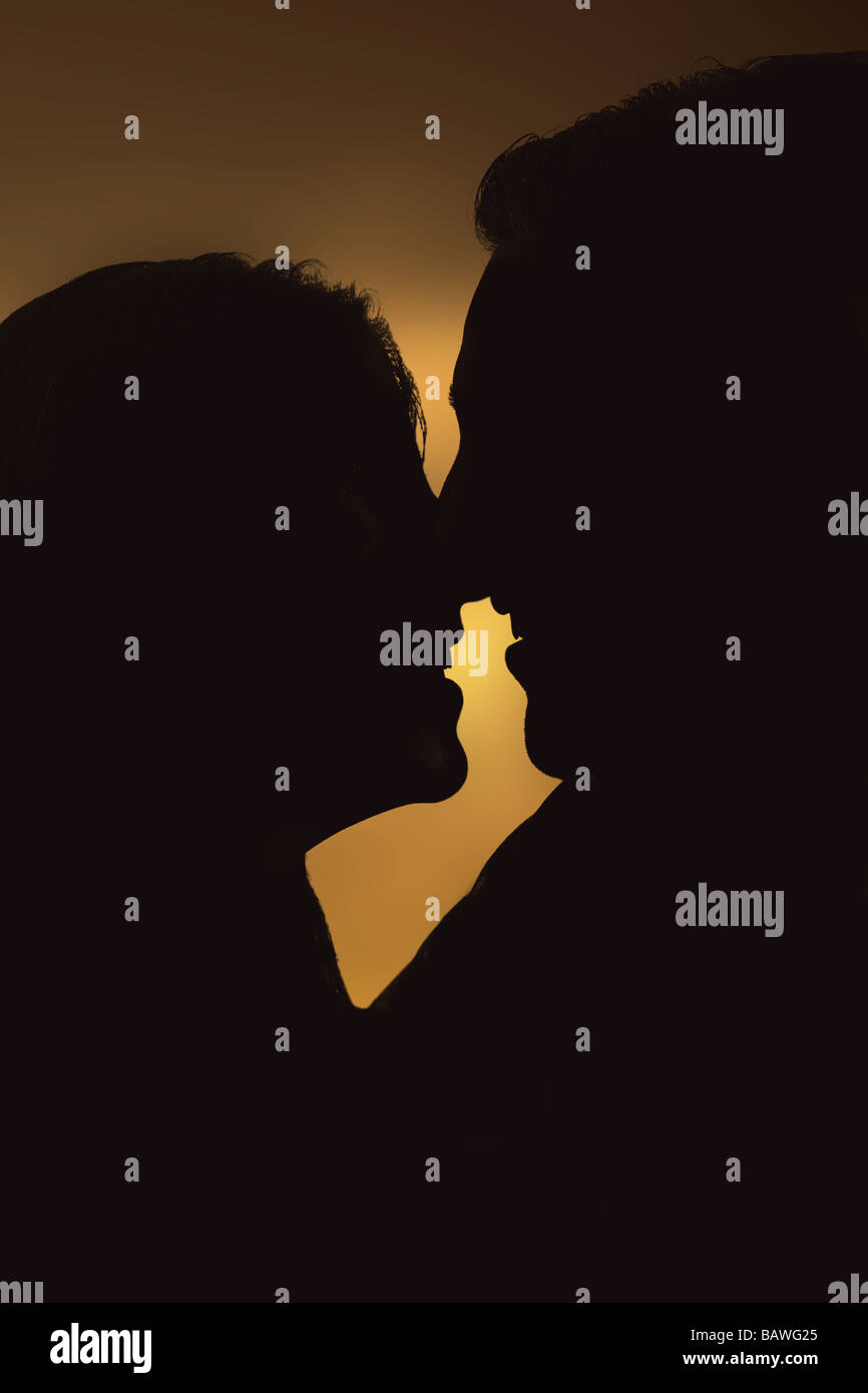 beautiful silhouette of a couple enjoying the sunset Stock Photo - Alamy