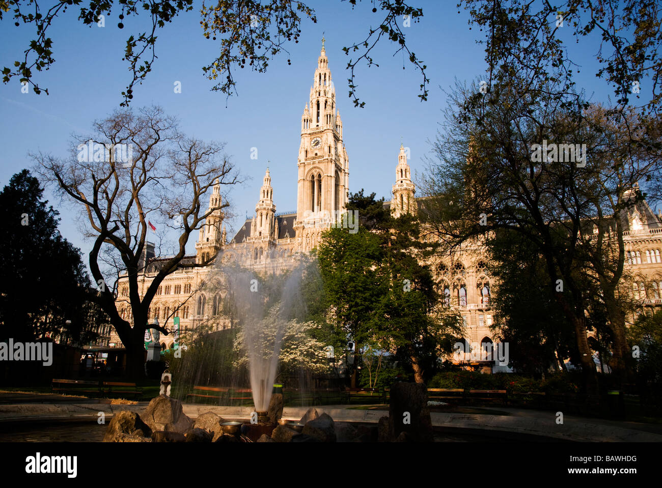 early morning view of the Viennese Rathaus from the park with fountain in the forefront Stock Photo