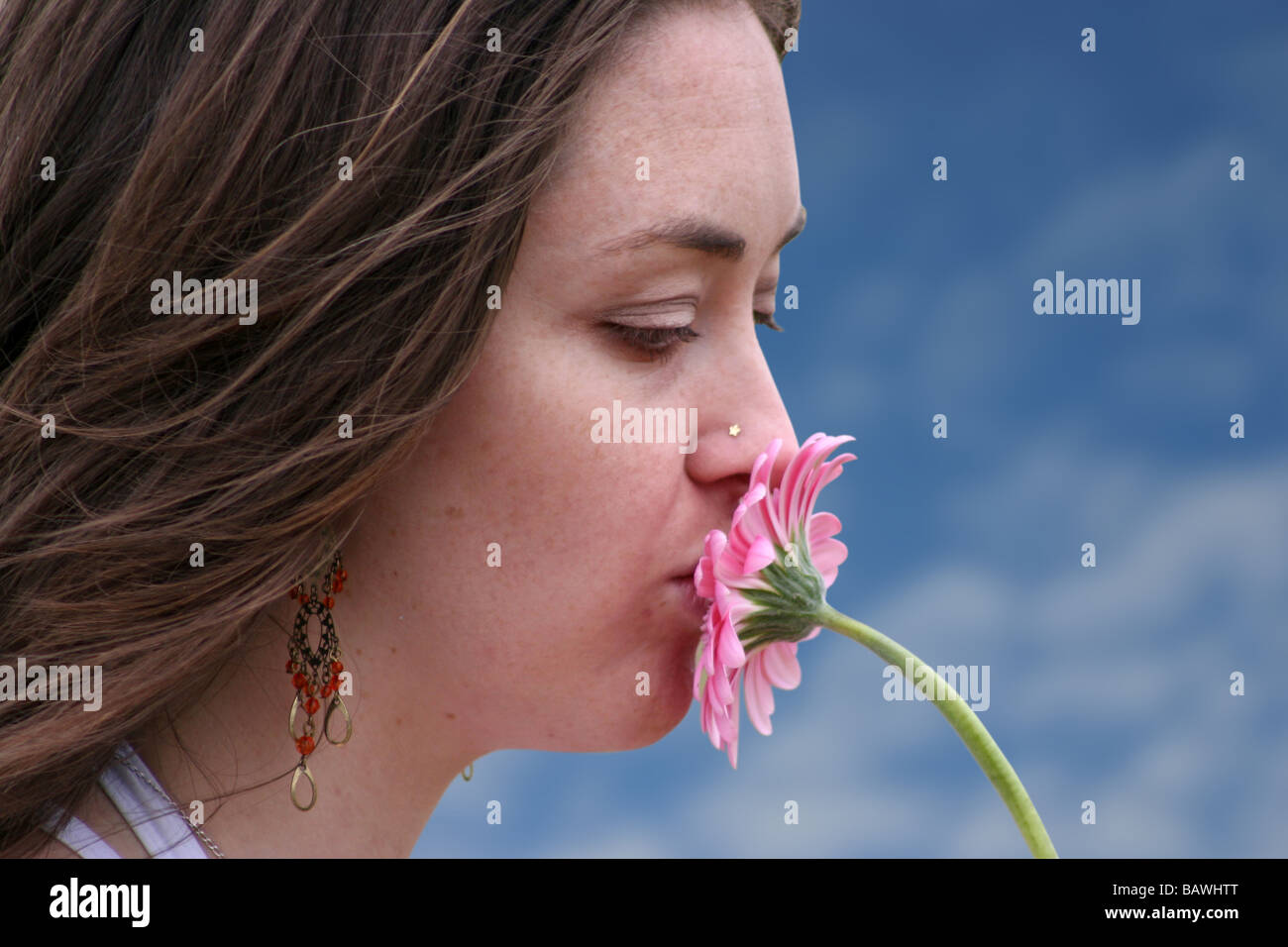 Kissing The Flower In Bloom beautiful girl kissing a flower in colour Stock Photo - Alamy