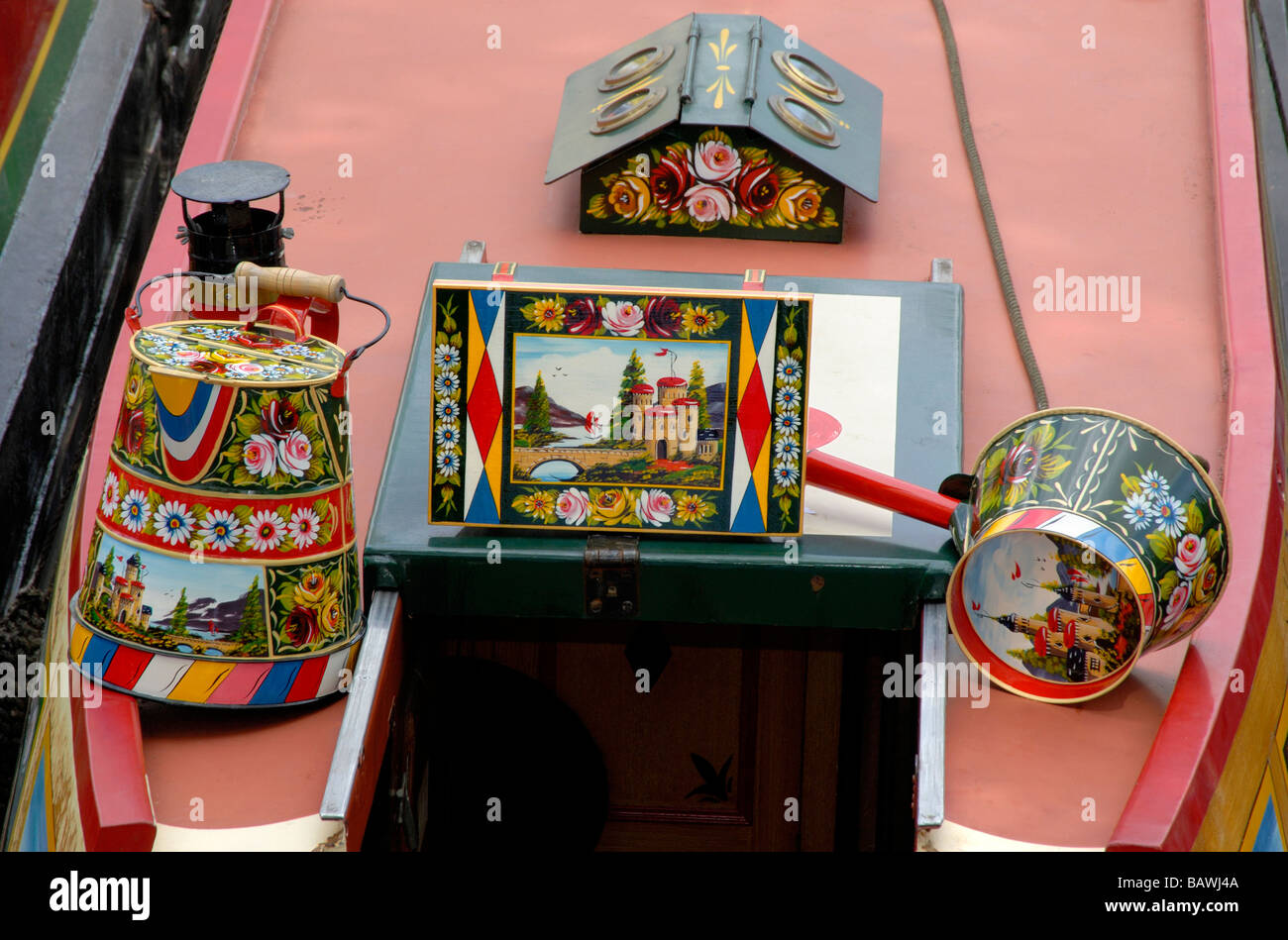 Canalware hand painted with traditional castles and roses around rear hatch and pigeon box of a narrowboat, London, England Stock Photo