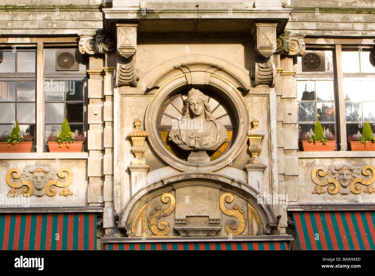 Stone bust carving of Saint Barbara on the Tailor's guild house la Taupe Building in the Grand Place, Brussels, Belgium Stock Photo