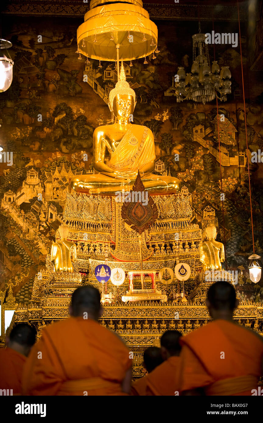 Monks attending afternoon prayer in Phra Ubosot Hall. Wat Pho, Bangkok, Thailand Stock Photo