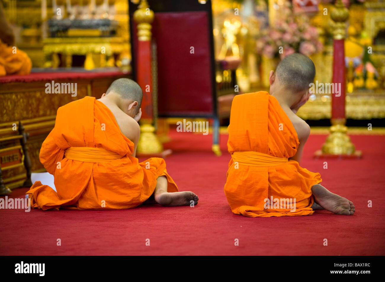 Two young Monks sleeping though afternoon prayer. Wat Pho, Bangkok