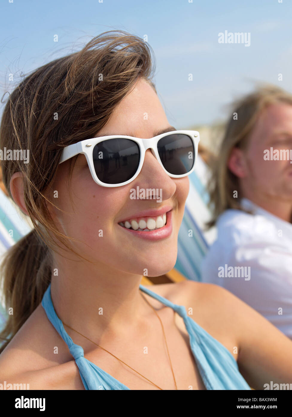 Beautiful young woman with sunglasses taking a sunbath Stock Photo