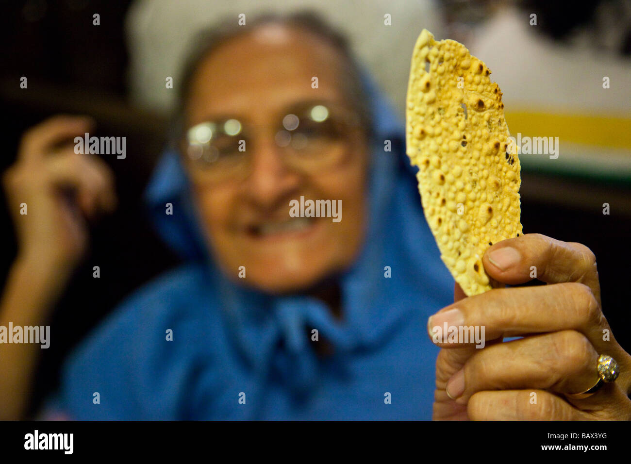 Gujarati Woman Holding a Papad or Papadam Indian Lentle Chip at a Restaurant in Mumbai India Stock Photo