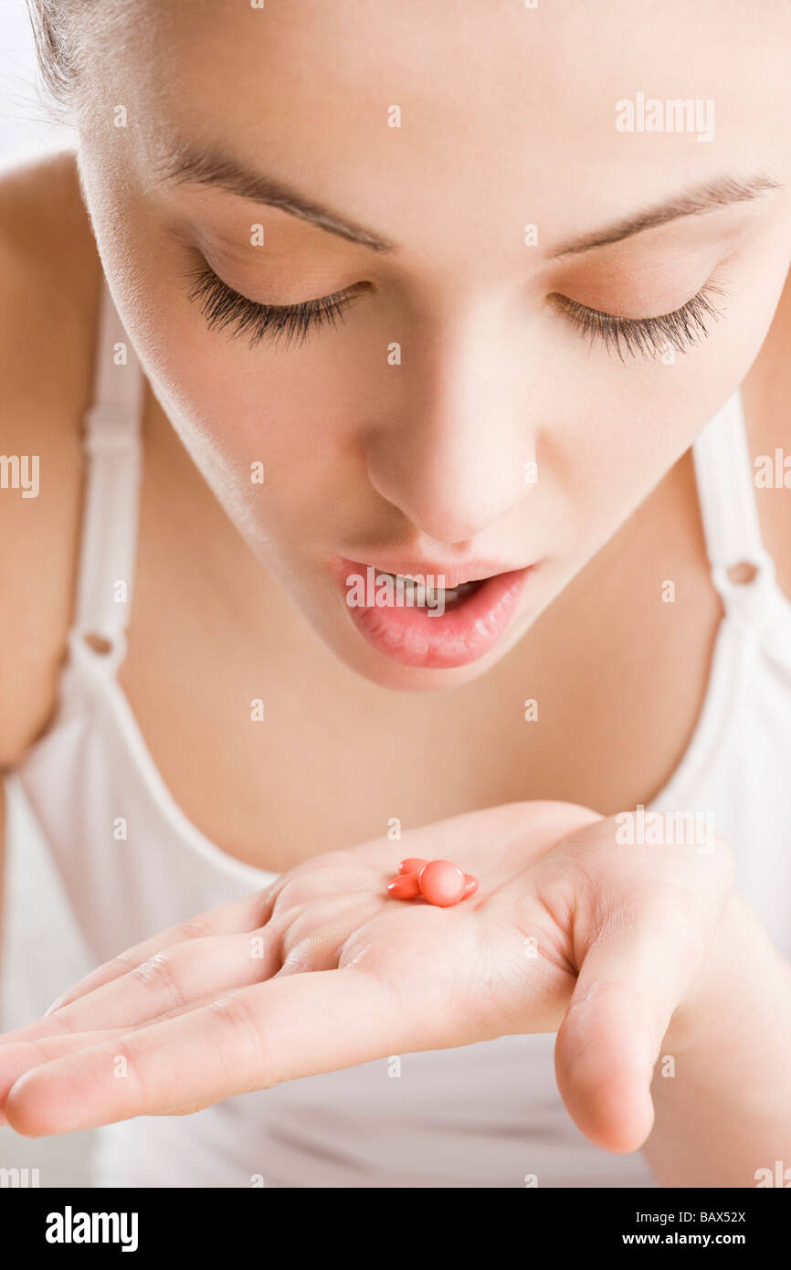young woman with vitamins on hand Stock Photo