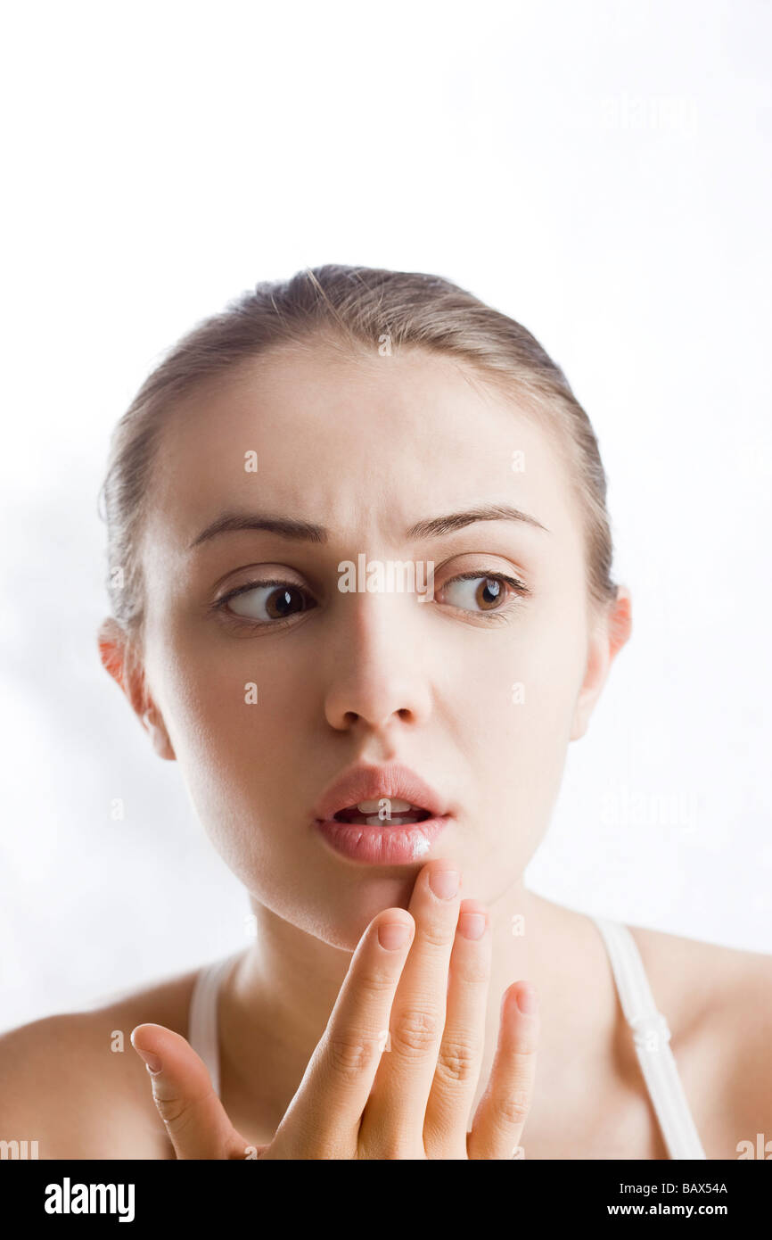 young woman applying ointment on herpes Stock Photo