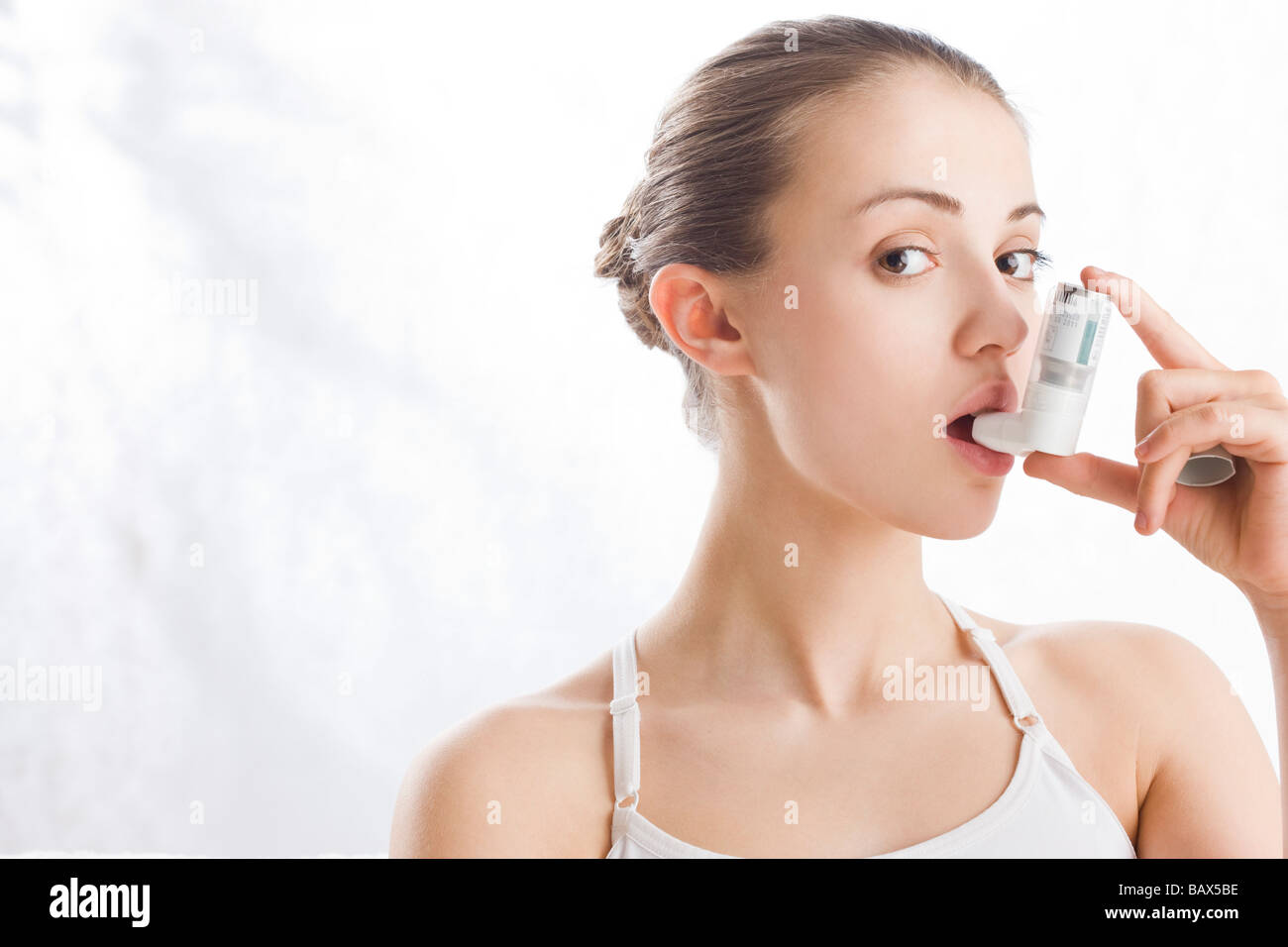 woman using inhaler Stock Photo