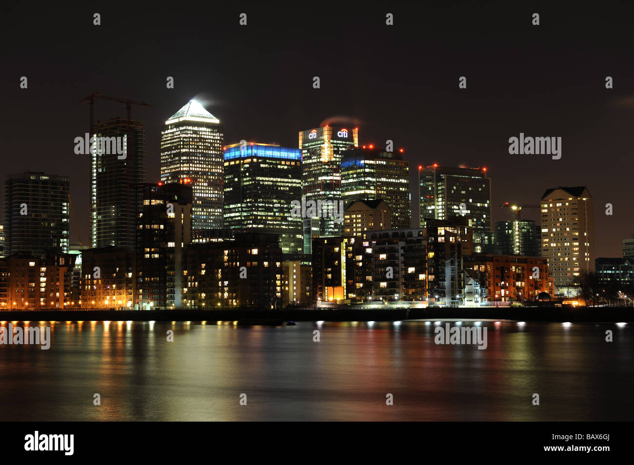 London's financial district including Canary Wharf, HSBC and Barclays taken at night. Stock Photo
