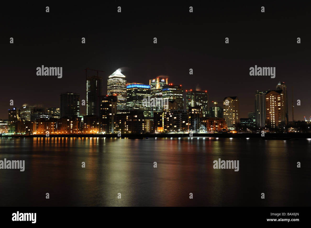 London's financial district including Canary Wharf, HSBC and Barclays taken at night. Stock Photo