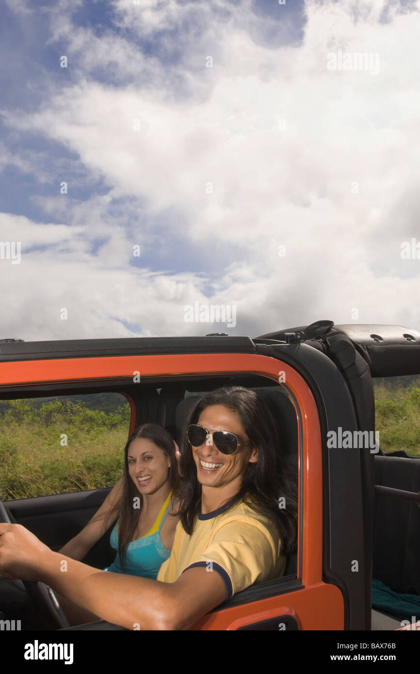 Portrait of couple sitting in jeep Stock Photo Alamy