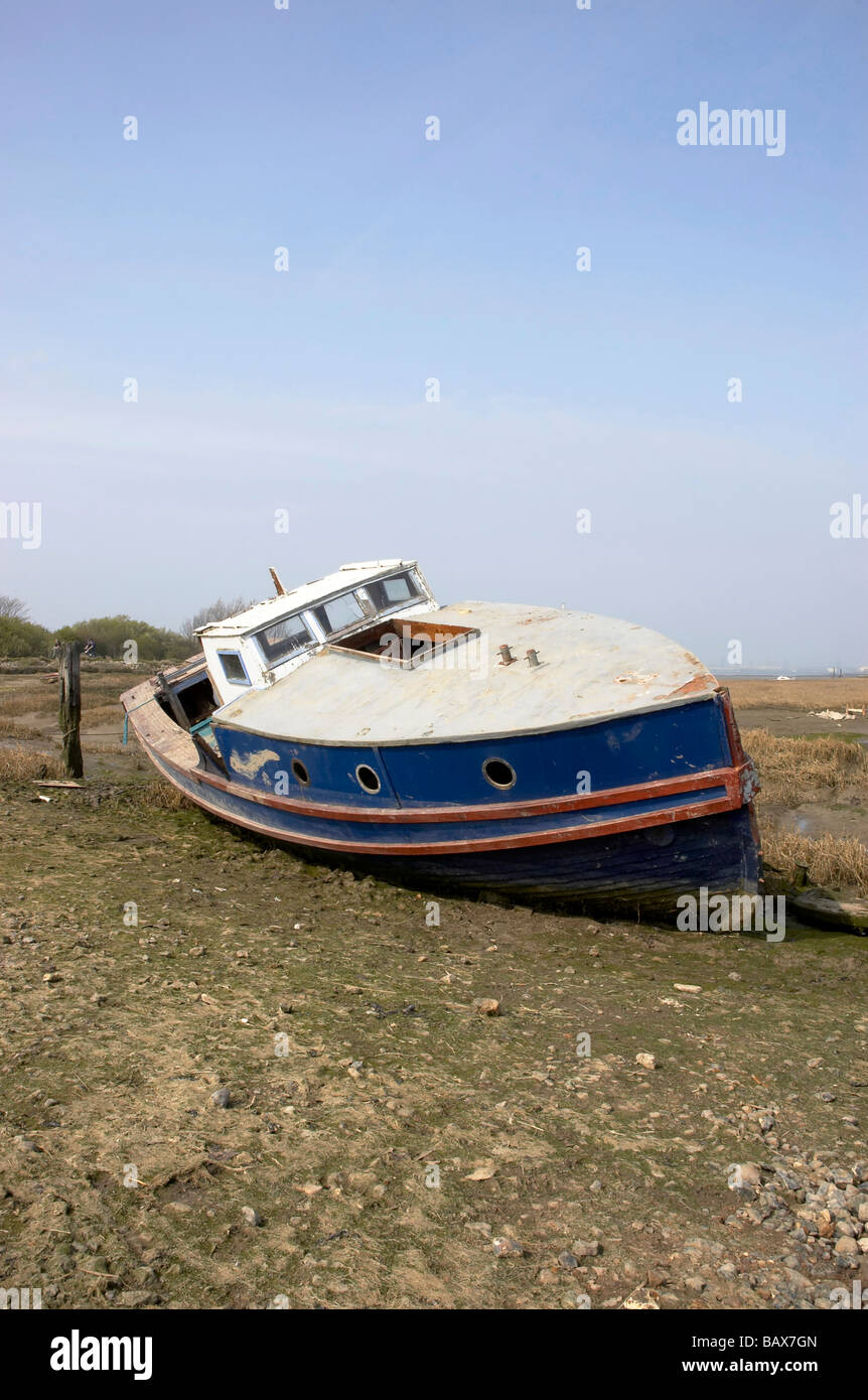 A small fishing boat at low tide Stock Photo - Alamy
