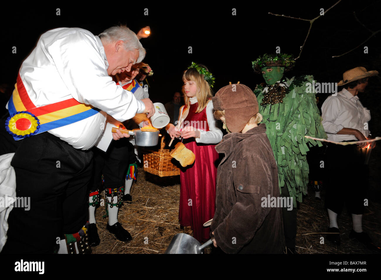 Mendip Morris Men pour cider onto toast for the Wassail Queen during Thatchers Cider Wassailing event Stock Photo