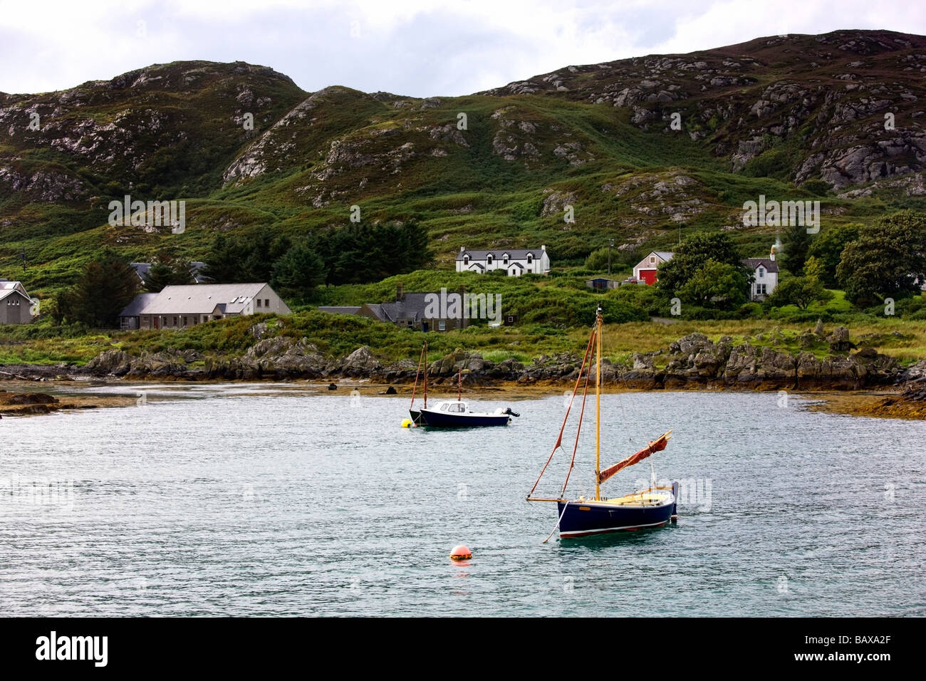 Isle of Colonsay, Scotland; Sailboats and coastal dwellings Stock Photo