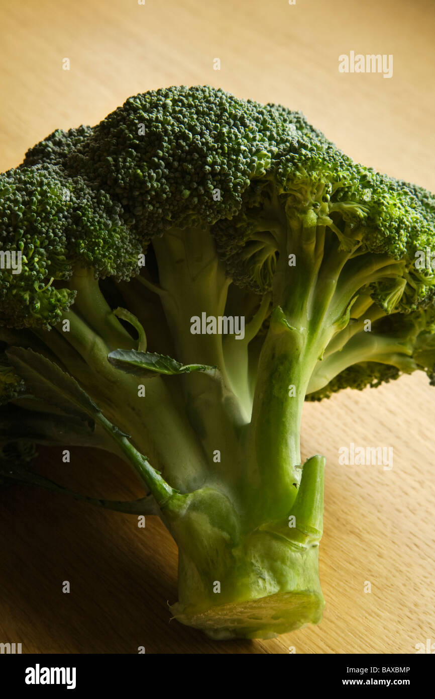 Head of broccoli on a wooden surface. Stock Photo