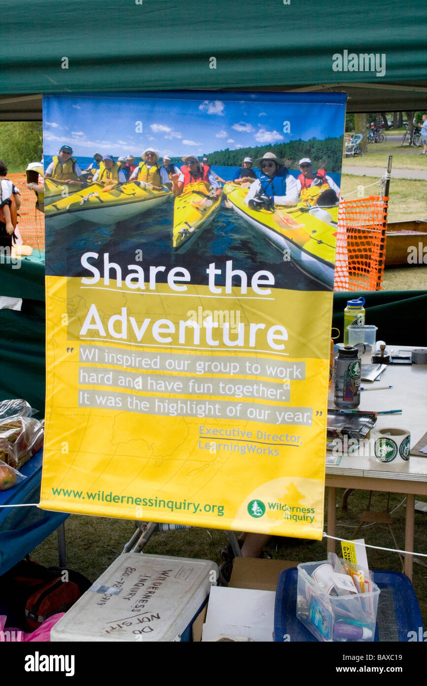Poster at Wilderness Inquiry booth providing group canoe rides to all. Aquatennial Beach Bash
