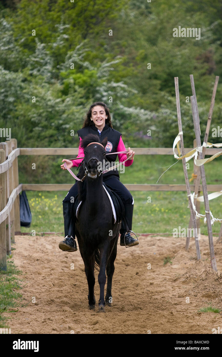 a girl is running a horse at the maneage Stock Photo Alamy
