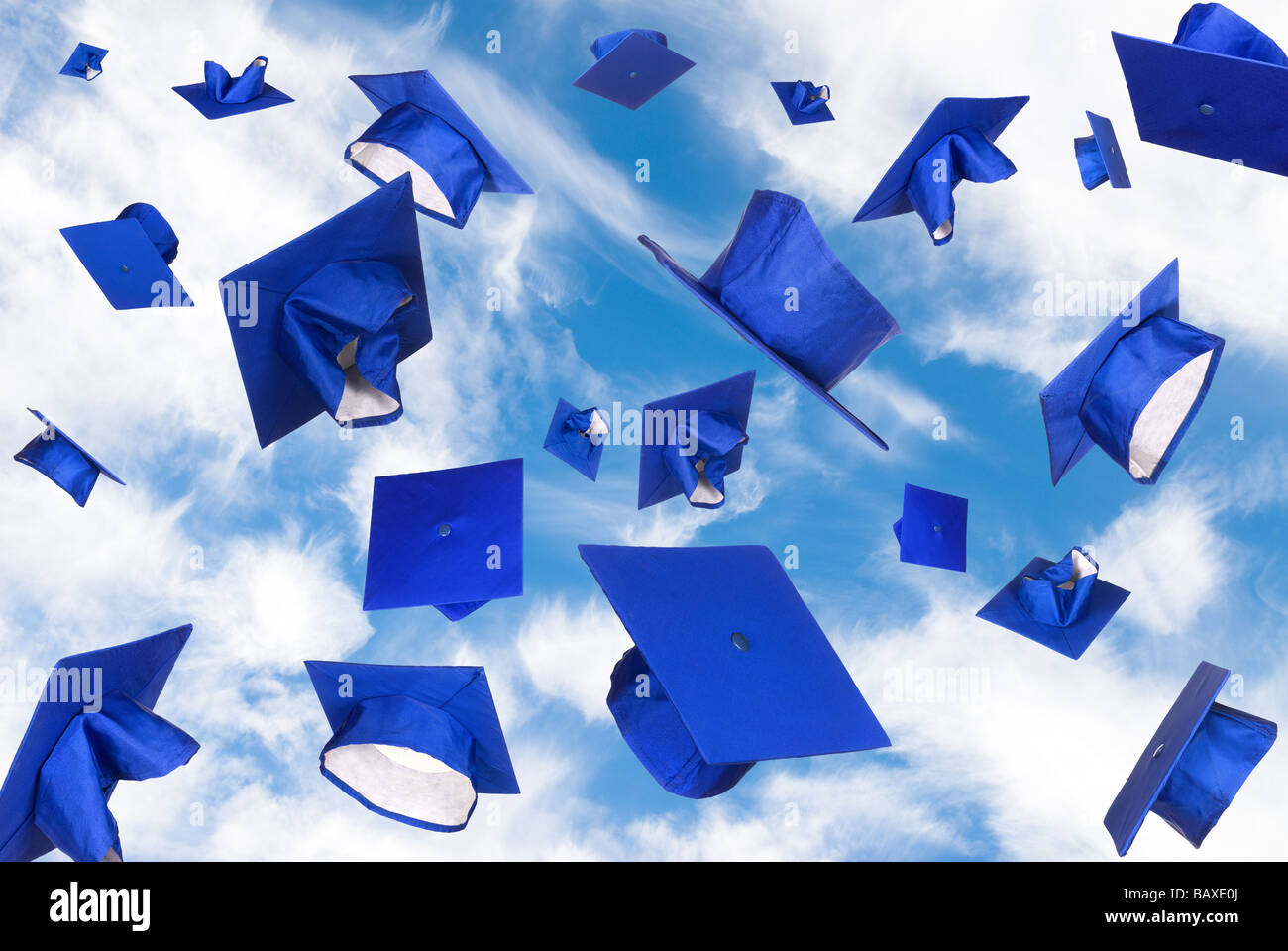 Graduation caps fly in the air in a moment of celebration Stock Photo