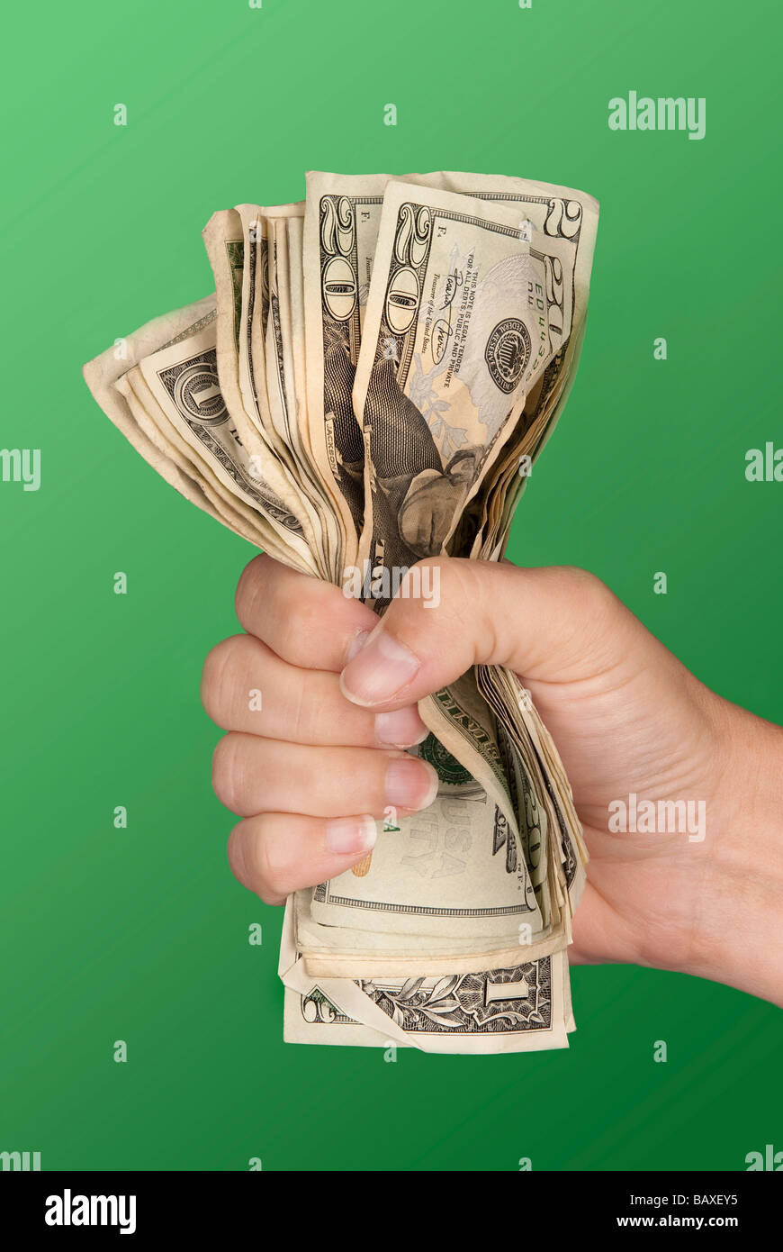 A woman grips a wad of cash hoping she doesn't lose it Stock Photo