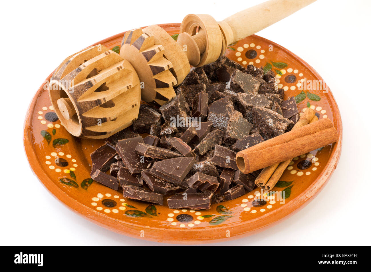 https://c8.alamy.com/comp/BAXF4H/chopped-mexican-chocolate-cinnamon-sticks-and-a-molinillo-on-a-clay-BAXF4H.jpg