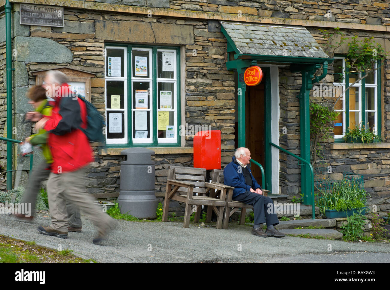 Walkers passing the Post Office in the village of Troutbeck, Lake District National Park, Cumbria, England UK Stock Photo