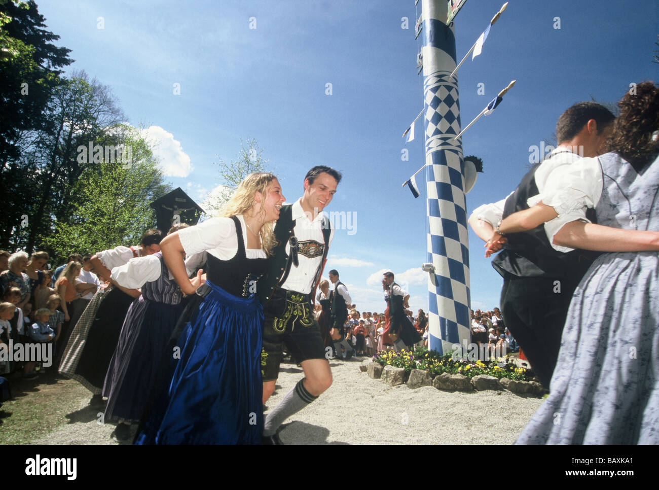 Young men and women dancing around the maypole at the Maypole festival in Holzhausen, Bavaria, Germany Stock Photo