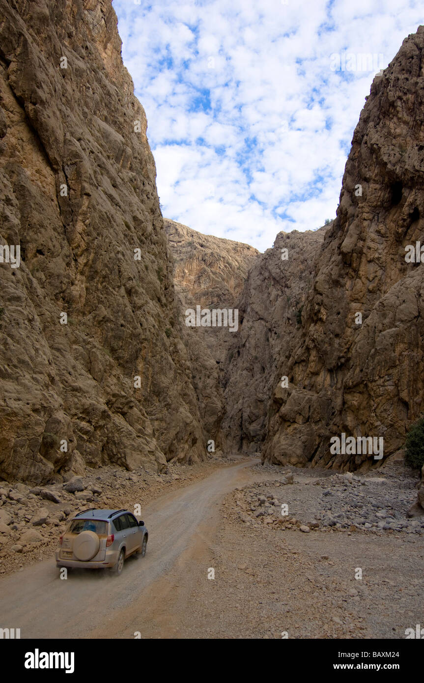 4x4 jeep driving through a canyon, dirt road, mountain landscape