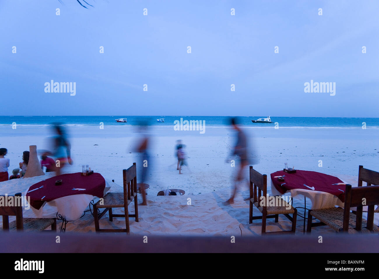 People passing a beach restaurant, The Sands, at Nomad, Diani Beach, Kenya Stock Photo