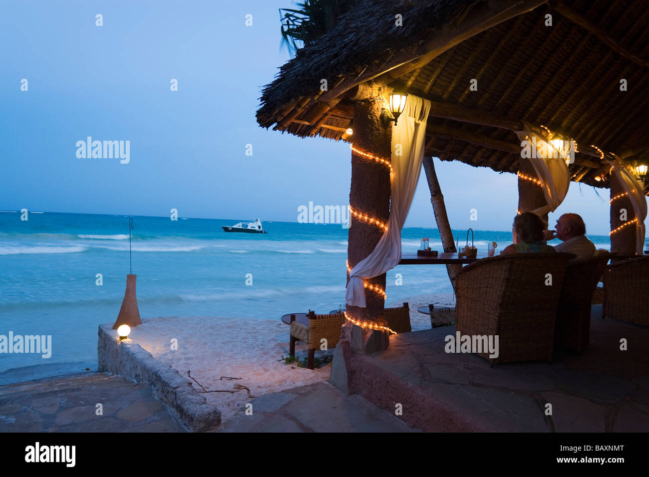 Couple sitting in a beach bar, The Sands, at Nomad, Diani Beach, Kenya Stock Photo