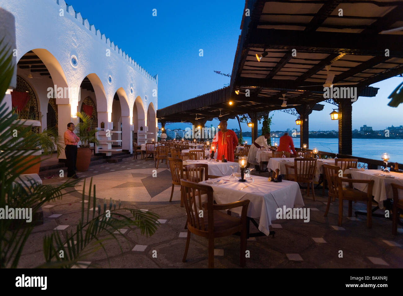 Waiters decorating tables on terrace of the restaurant Tamarind