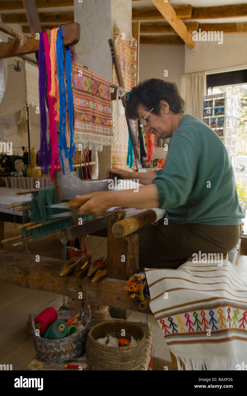 Woman weaving at a weaving loom in a local history museum, Fythi