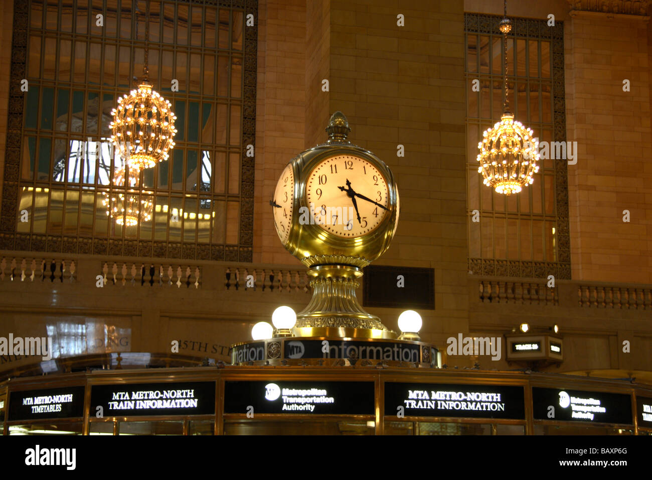 Clock & chandeliers above the central information booth in Grand Central Terminal (Grand Central Station), New York. Stock Photo