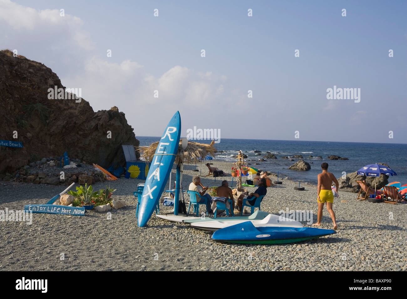 People relaxing on the beach Relax sign, Akro Pornos, near Polis, South