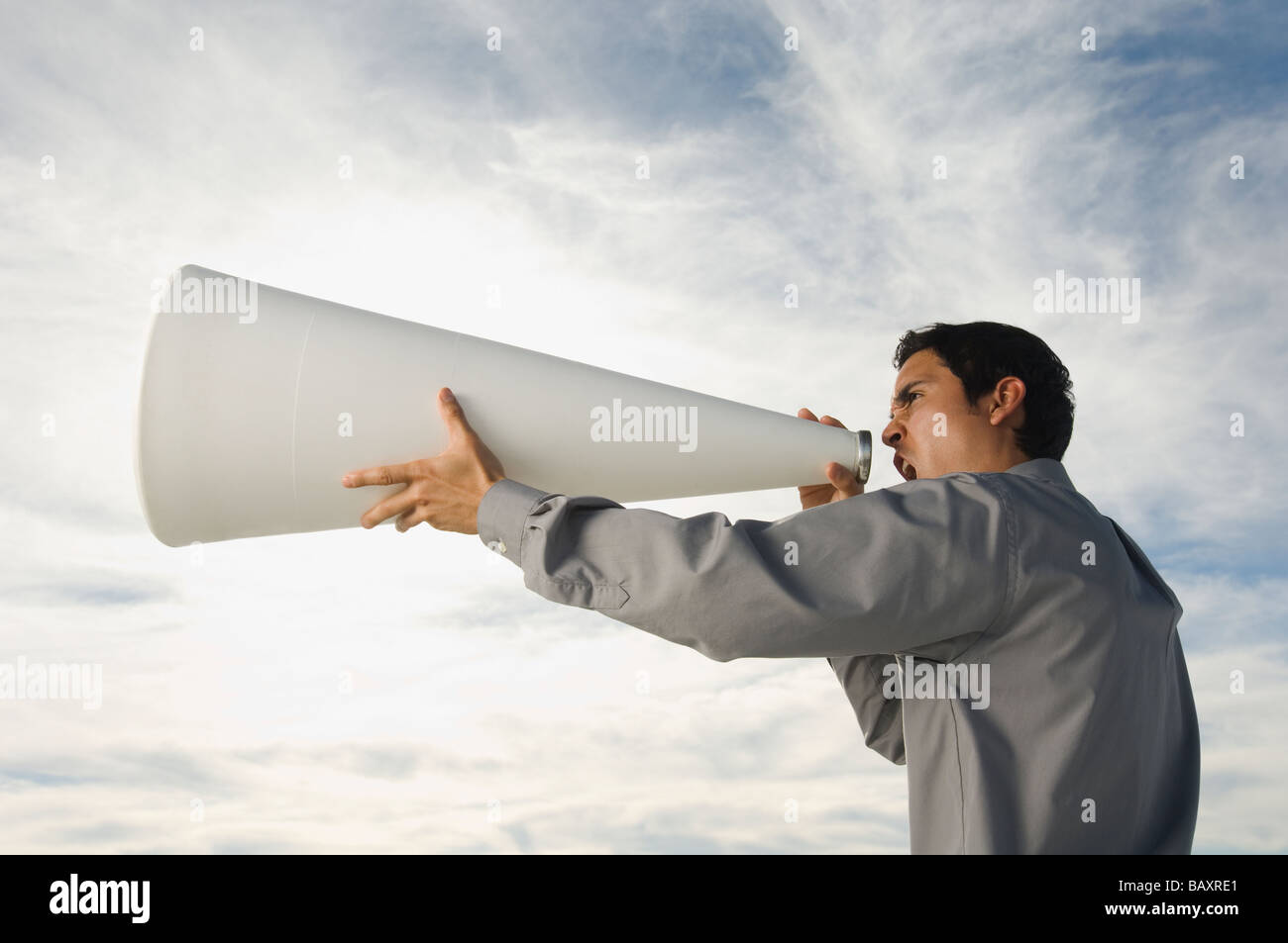 Hispanic businessman yelling into megaphone Stock Photo Alamy