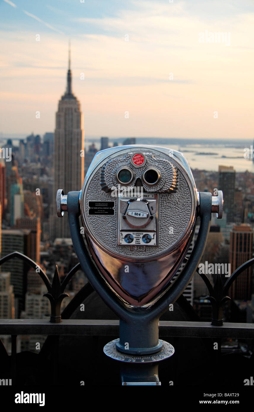 A viewing telescope on the Top of the Rock observatory, Rockefeller Center,  New York looking towards the Empire State Building Stock Photo - Alamy