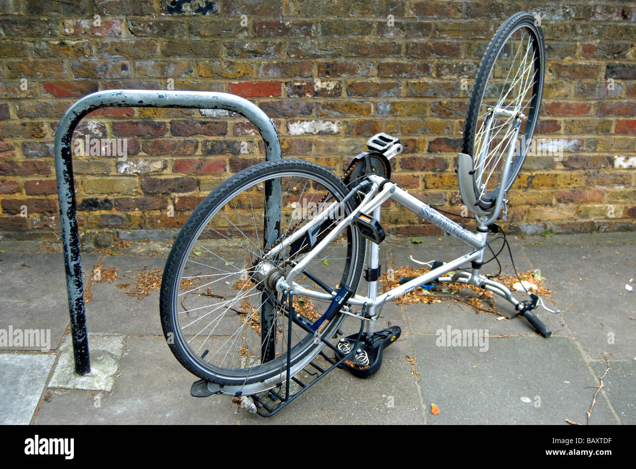 upside down bicycle locked to a british cycle stand Stock Photo Alamy