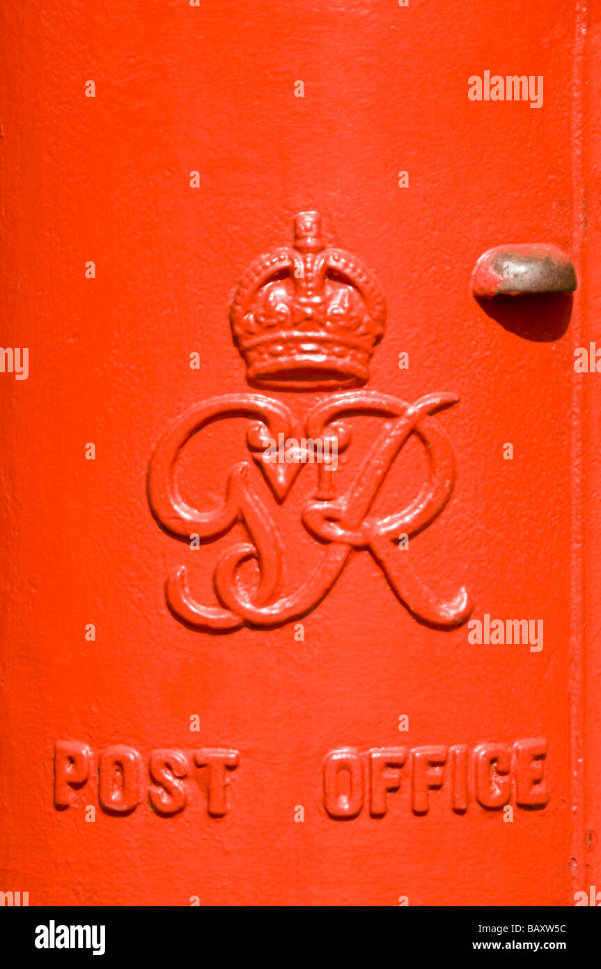 Vertical close up of an iconic red British pillar box - a free standing type A model from the reign of King George VI. Stock Photo