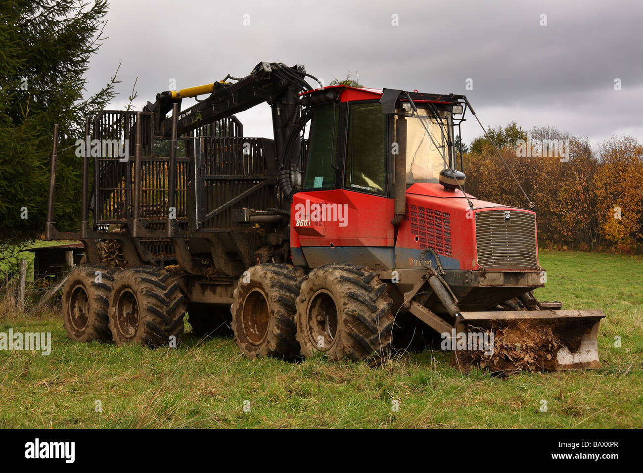 a Valmet log transporter parked in a field beside woodland Limousin France Stock Photo