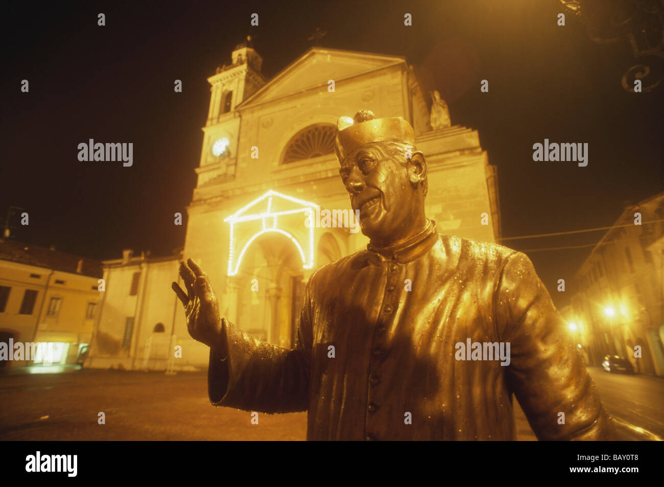 Don Camillo's statue in bronze in front of his church in Brescello, Parma province, Emilia Romagna, Italy Stock Photo