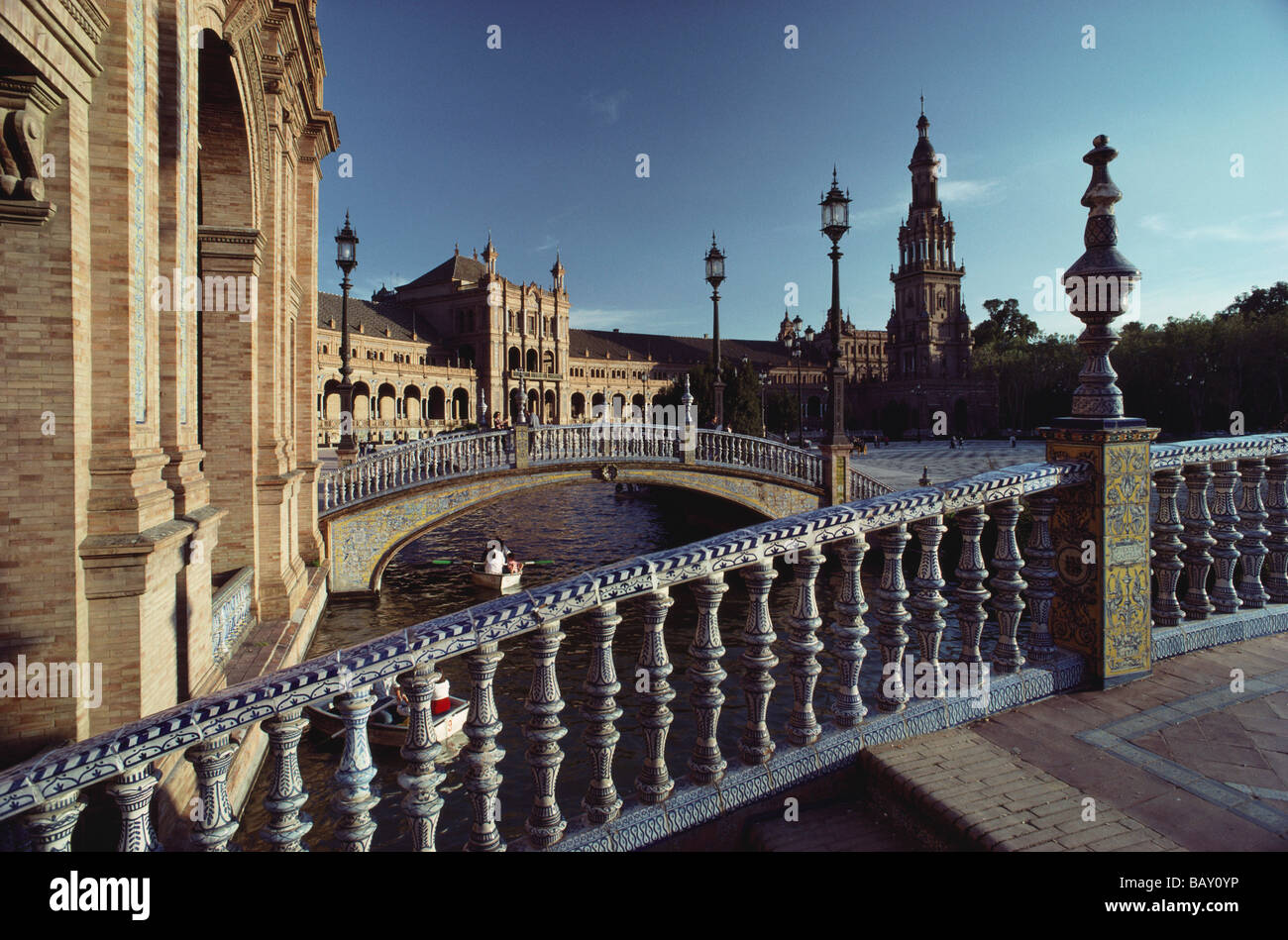 Delicate bridges with ceramic balustrades over canal with rowing boats at the Palacio Central, Seville, Andalusia, Spain Stock Photo