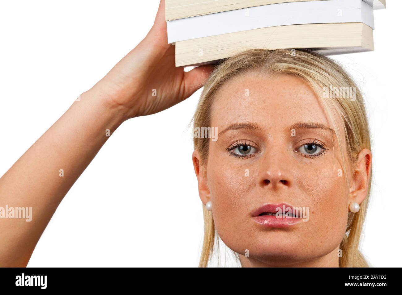 pretty young student holding books on her head Stock Photo - Alamy