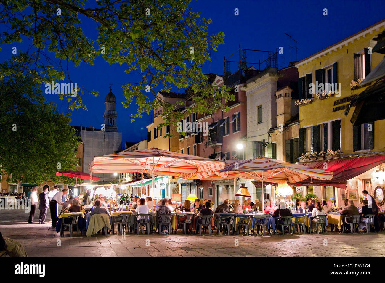 People sitting outside a restaurant bar, Campo Santa Margherita, Venice, Veneto, Italy Stock Photo