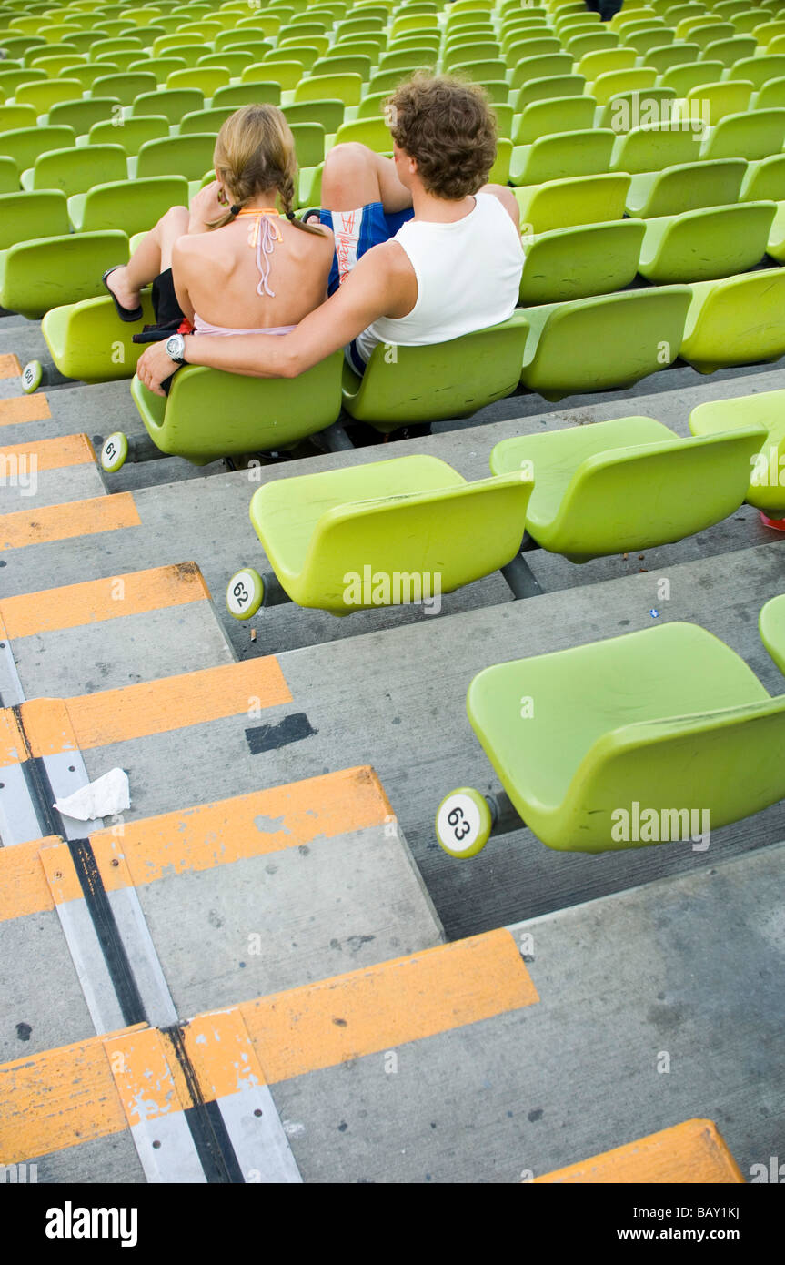 Young couple sitting on the bleachers of Munich's Olympic Stadium
