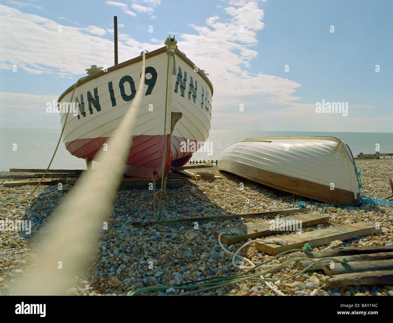 Fishing boats on a shingle beach, Pevensey Beach, Pevensey Bay, East