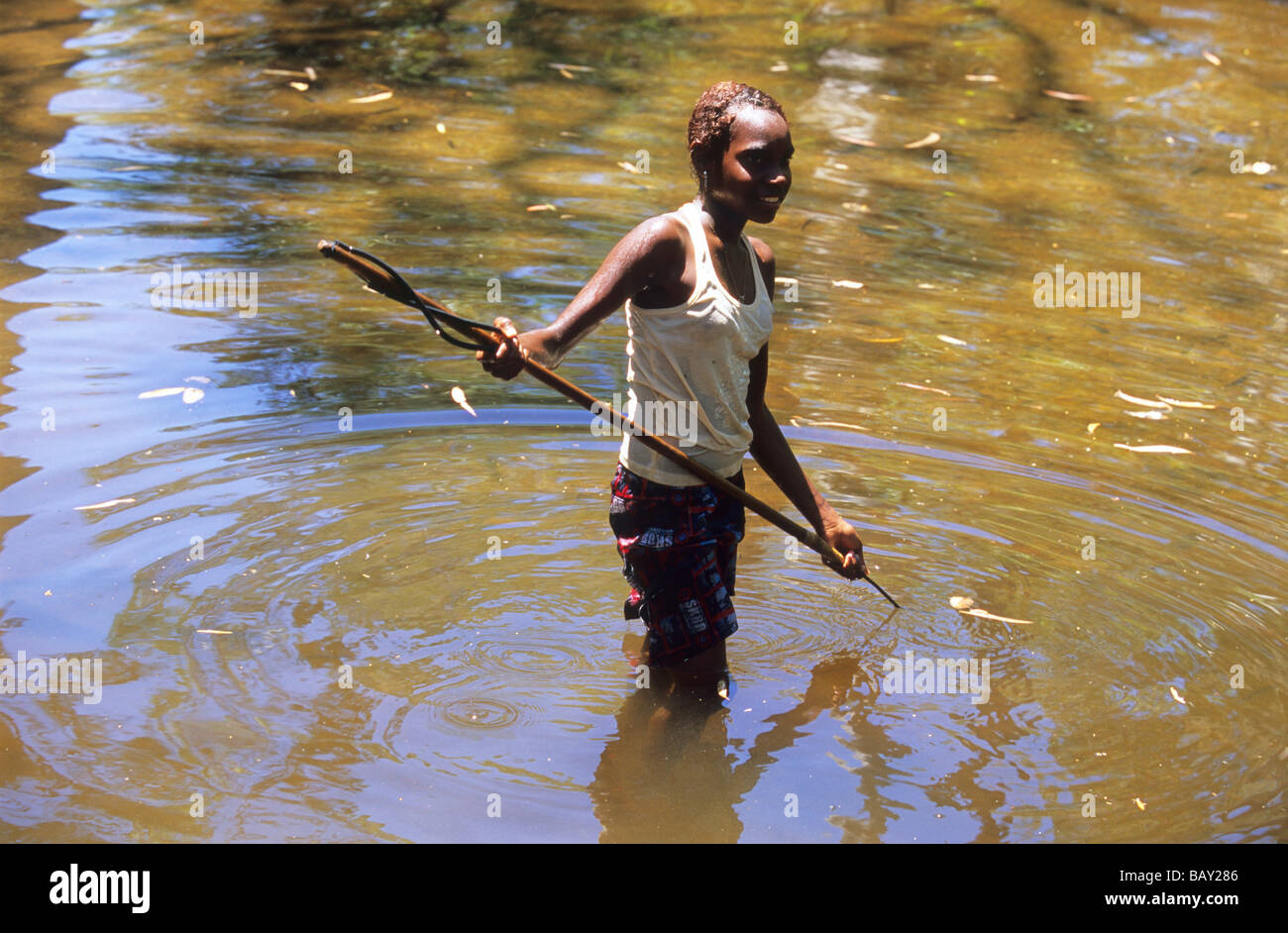 Young Aborigional girl spear fishing in the Coen River, Queensland